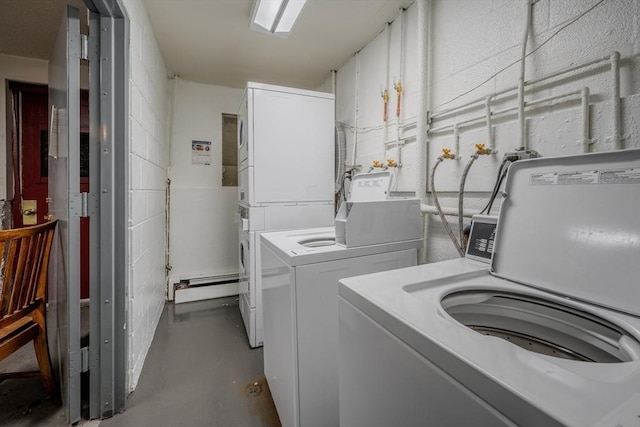 laundry area with stacked washer and dryer, washing machine and dryer, and baseboard heating