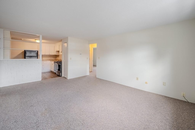 unfurnished living room with light carpet