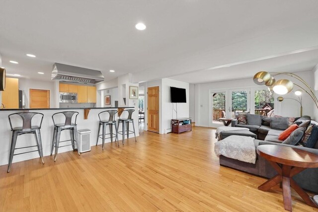 living room with recessed lighting and light wood-style floors