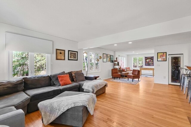 living area with plenty of natural light, recessed lighting, and light wood-style flooring