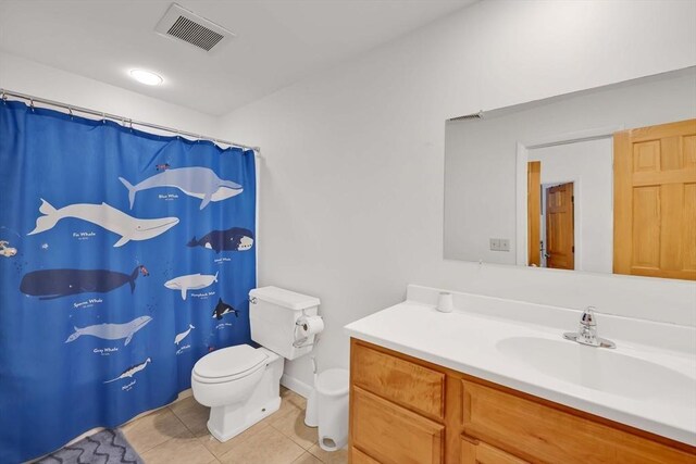 bathroom featuring visible vents, tile patterned flooring, curtained shower, vanity, and toilet