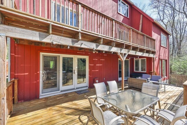 deck with french doors and outdoor dining space