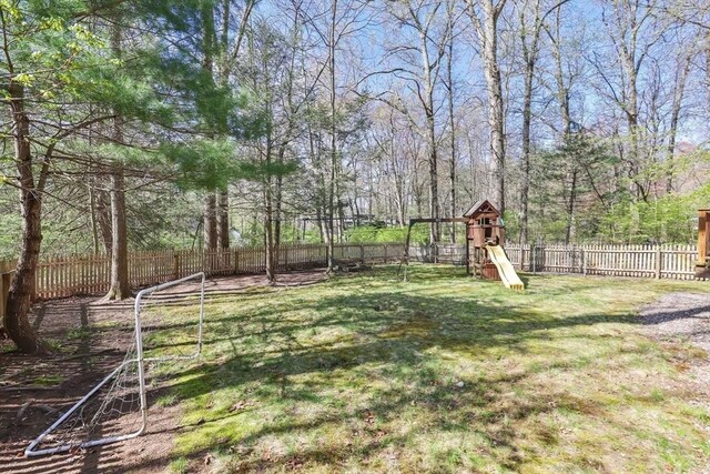 view of yard featuring a playground and a fenced backyard