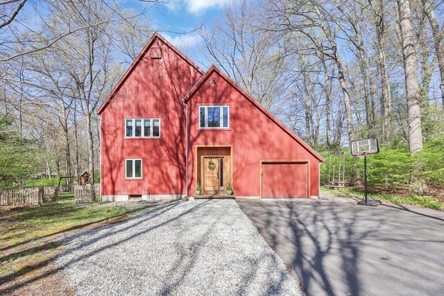 exterior space with aphalt driveway and fence