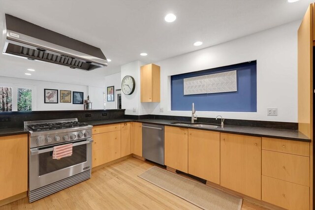 kitchen featuring exhaust hood, light brown cabinetry, a sink, light wood-style flooring, and stainless steel appliances