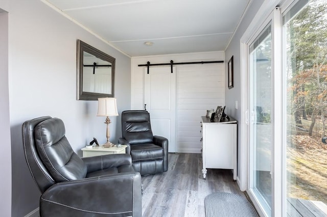1 Ladd Ave, Wareham, MA 02571 - sitting room featuring a barn door, wood finished floors, and ornamental molding