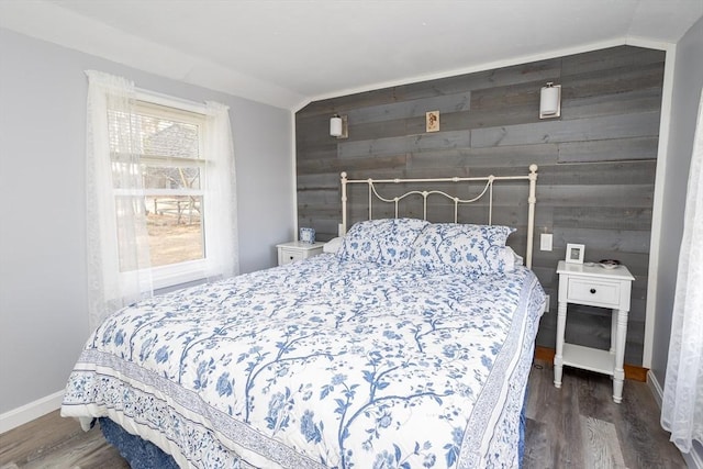 1 Ladd Ave, Wareham, MA 02571 - bedroom featuring vaulted ceiling, wooden walls, wood finished floors, an accent wall, and baseboards