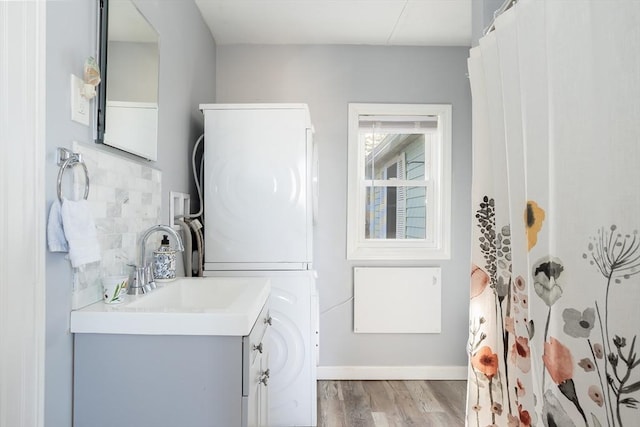 1 Ladd Ave, Wareham, MA 02571 - full bath with stacked washer and clothes dryer, wood finished floors, vanity, and baseboards