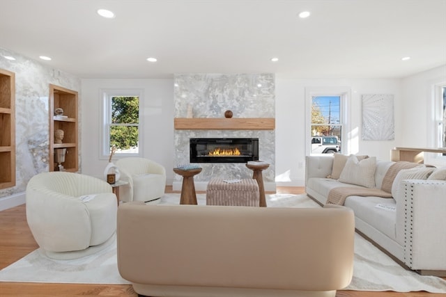 living room featuring light hardwood / wood-style floors and a fireplace