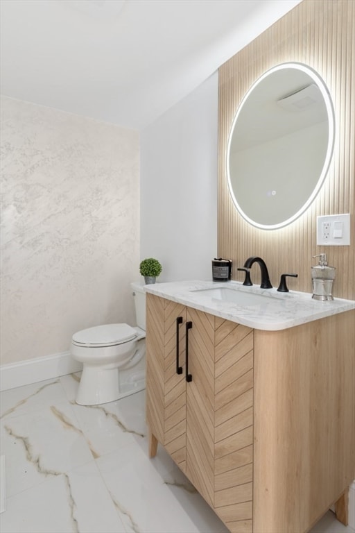 bathroom featuring vanity and toilet