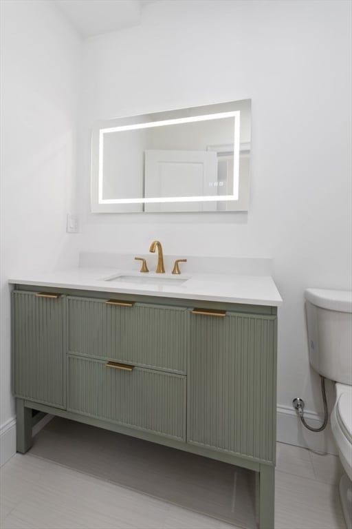 bathroom featuring tile patterned flooring, vanity, and toilet