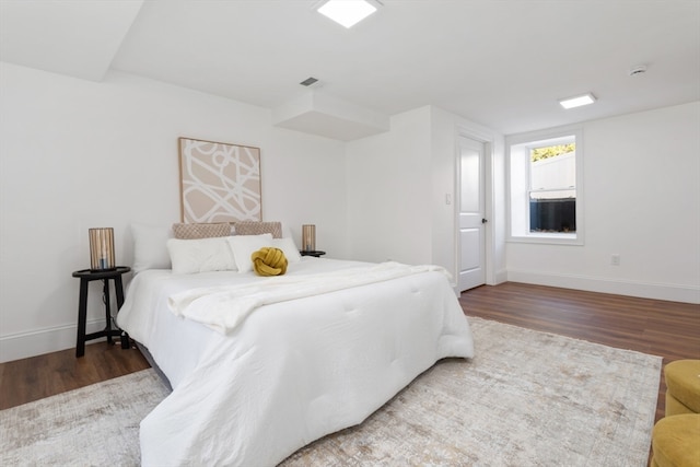 bedroom with dark hardwood / wood-style floors