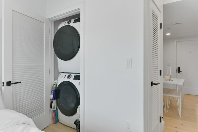50 Leo M Birmingham Pkwy Unit 405, Boston, MA 02135 - washroom featuring stacked washer / dryer, light wood-type flooring, and recessed lighting