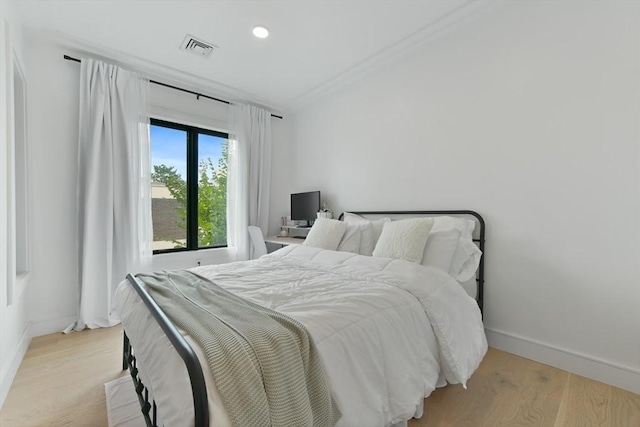 50 Leo M Birmingham Pkwy Unit 405, Boston, MA 02135 - bedroom with baseboards, light wood-type flooring, recessed lighting, and ornamental molding