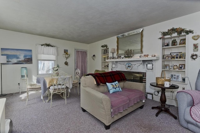 carpeted living room with a glass covered fireplace and a textured ceiling