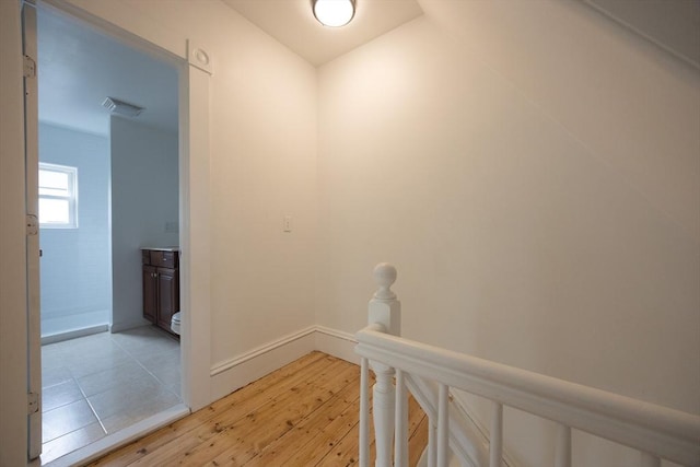 27 Union St Unit 27, Natick, MA 01760 - hallway with light wood-style flooring and an upstairs landing
