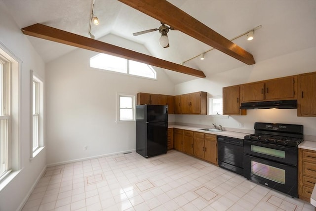 27 Union St Unit 27, Natick, MA 01760 - kitchen with black appliances, under cabinet range hood, track lighting, light countertops, and brown cabinetry
