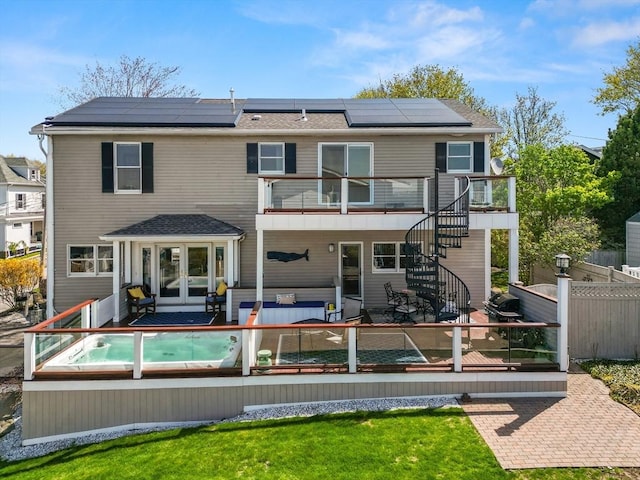 1 W Cliff St, Nahant, MA 01908 - rear view of house with french doors, roof mounted solar panels, a patio, a deck, and stairs