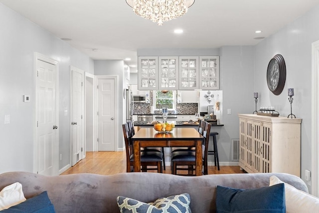 1 W Cliff St, Nahant, MA 01908 - dining space with light wood-style flooring, a chandelier, recessed lighting, and baseboards
