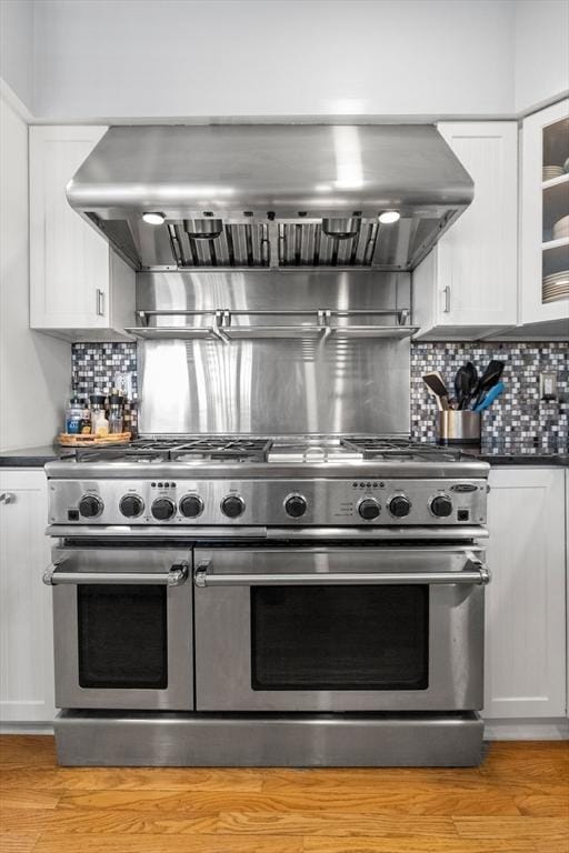 1 W Cliff St, Nahant, MA 01908 - kitchen featuring double oven range, exhaust hood, white cabinets, and dark countertops