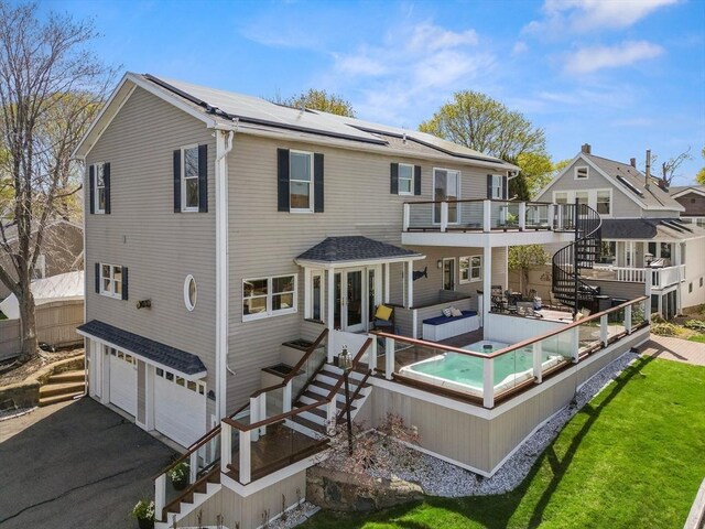 1 W Cliff St, Nahant, MA 01908 - back of house with solar panels, a garage, stairway, driveway, and a jacuzzi