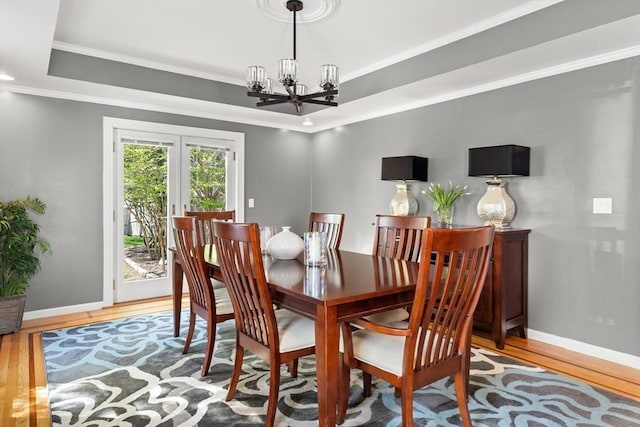 1 W Cliff St, Nahant, MA 01908 - dining room with a chandelier, wood finished floors, a tray ceiling, french doors, and baseboards