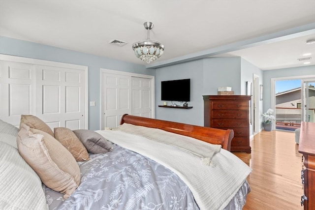 1 W Cliff St, Nahant, MA 01908 - bedroom with a chandelier, light wood-style flooring, and two closets