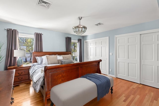 1 W Cliff St, Nahant, MA 01908 - bedroom featuring multiple closets, multiple windows, light wood-style floors, and a chandelier