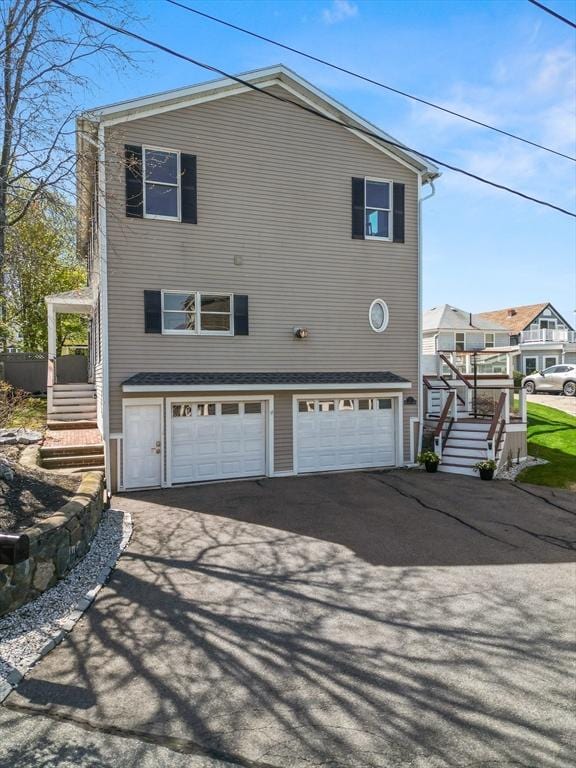 1 W Cliff St, Nahant, MA 01908 - view of home's exterior with stairs, an attached garage, and driveway