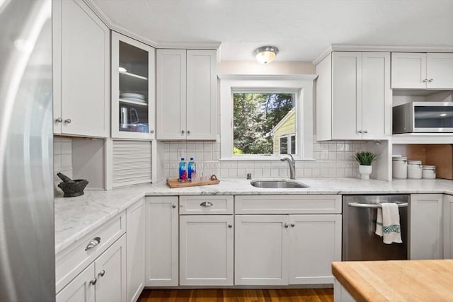 11 Laurel Dr, Scituate, MA 02066 - kitchen featuring stainless steel appliances, decorative backsplash, glass insert cabinets, and light stone countertops