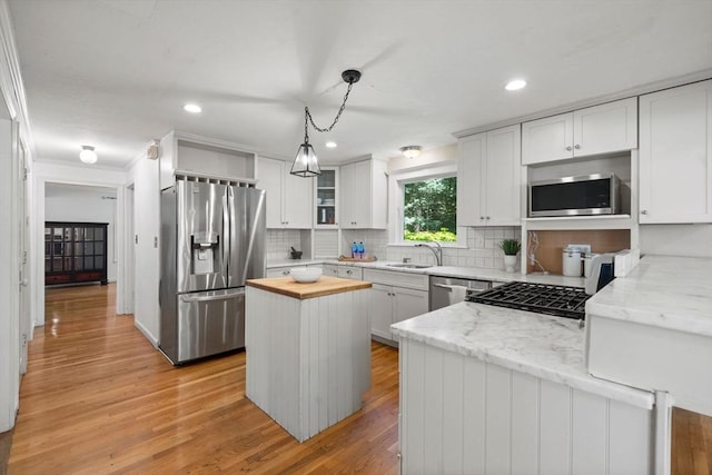 11 Laurel Dr, Scituate, MA 02066 - kitchen featuring appliances with stainless steel finishes, wooden counters, tasteful backsplash, light wood finished floors, and crown molding