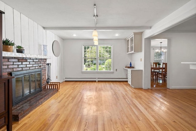 11 Laurel Dr, Scituate, MA 02066 - unfurnished living room featuring baseboard heating, a fireplace, light wood-type flooring, a chandelier, and beamed ceiling