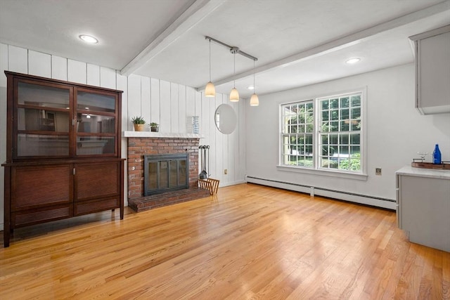 11 Laurel Dr, Scituate, MA 02066 - living room featuring a baseboard heating unit, beamed ceiling, light wood finished floors, and a brick fireplace