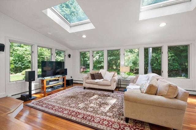 11 Laurel Dr, Scituate, MA 02066 - living area with plenty of natural light, a skylight, vaulted ceiling, a baseboard radiator, and wood finished floors