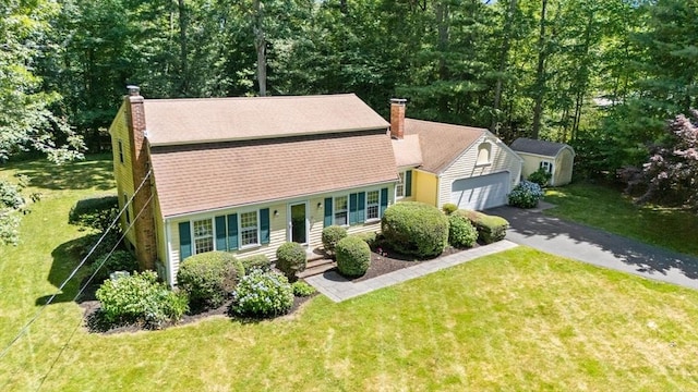 11 Laurel Dr, Scituate, MA 02066 - view of front facade with a chimney, asphalt driveway, an attached garage, and a front lawn