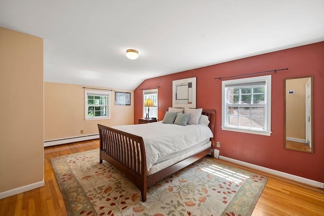 11 Laurel Dr, Scituate, MA 02066 - bedroom with a baseboard heating unit, multiple windows, vaulted ceiling, and wood finished floors