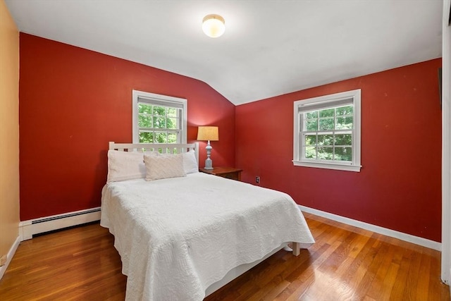 11 Laurel Dr, Scituate, MA 02066 - bedroom featuring baseboard heating, vaulted ceiling, multiple windows, and wood finished floors