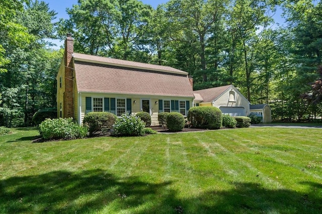 11 Laurel Dr, Scituate, MA 02066 - dutch colonial with a front lawn, a chimney, a gambrel roof, asphalt driveway, and a garage