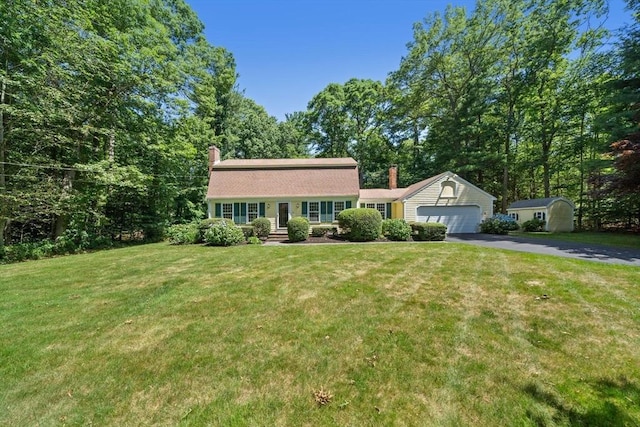 11 Laurel Dr, Scituate, MA 02066 - dutch colonial featuring an attached garage, driveway, a chimney, and a front yard