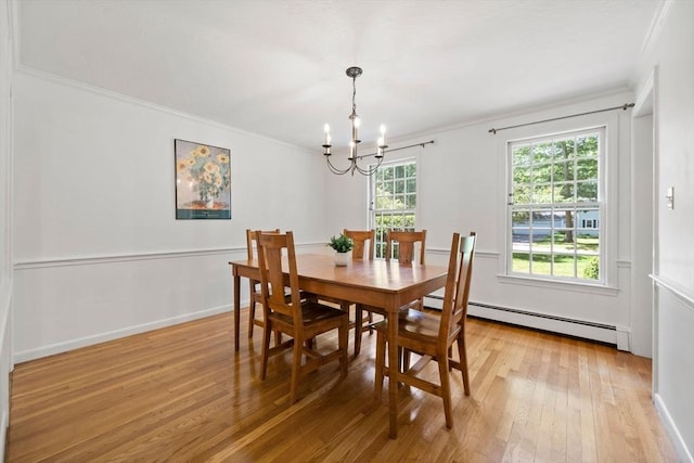 11 Laurel Dr, Scituate, MA 02066 - dining space with a baseboard heating unit, a chandelier, crown molding, and light wood-type flooring