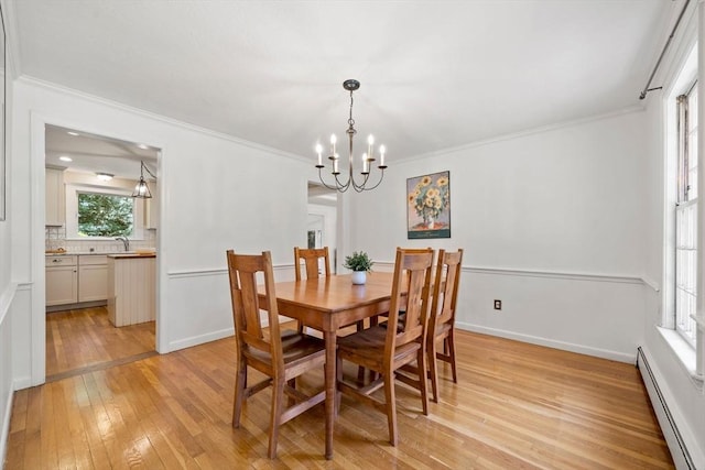 11 Laurel Dr, Scituate, MA 02066 - dining room featuring a baseboard radiator, light wood-type flooring, a chandelier, and crown molding