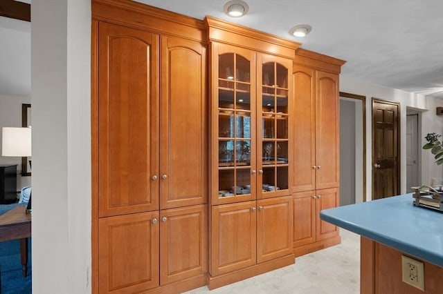 kitchen featuring glass insert cabinets and brown cabinets