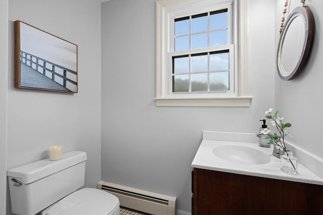 bathroom with a baseboard heating unit, toilet, vanity, and baseboards