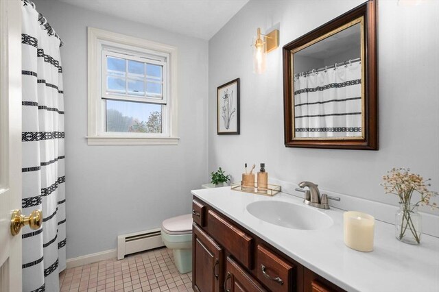 full bath with baseboard heating, toilet, vanity, baseboards, and tile patterned flooring