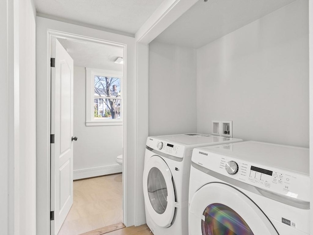 washroom featuring washing machine and clothes dryer