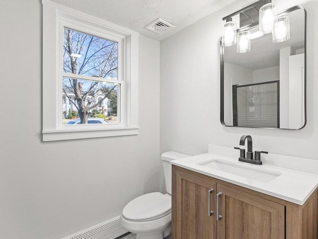 bathroom with baseboard heating, a textured ceiling, an enclosed shower, toilet, and vanity