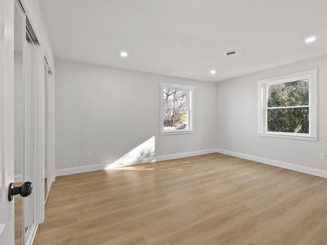 spare room featuring light hardwood / wood-style floors