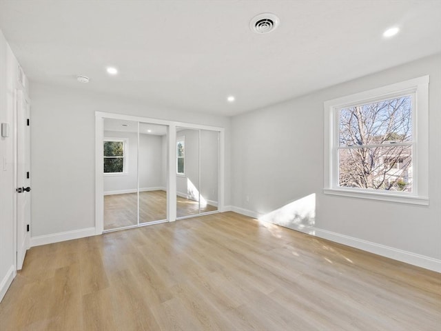 interior space featuring light hardwood / wood-style flooring and multiple closets