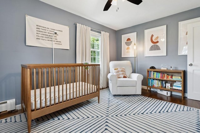 48 W Park Dr, Wakefield, MA 01880 - bedroom featuring a crib, wood finished floors, baseboards, and a baseboard radiator