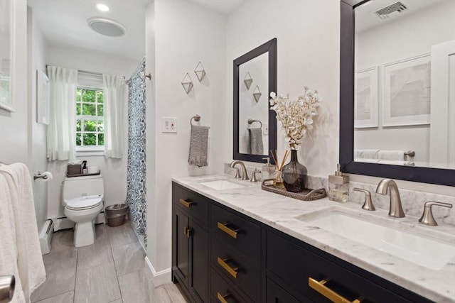 48 W Park Dr, Wakefield, MA 01880 - full bathroom featuring toilet, double vanity, a baseboard radiator, baseboard heating, and baseboards